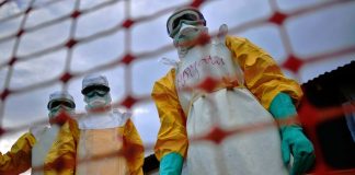 Healthcare workers wearing protective Ebola suits