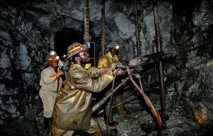 Gold miners work the Cooke Shaft in Johannesburg. Thousands of gold miners and their families are now seeking compensation for the sector's failure to protect miners from silicosis