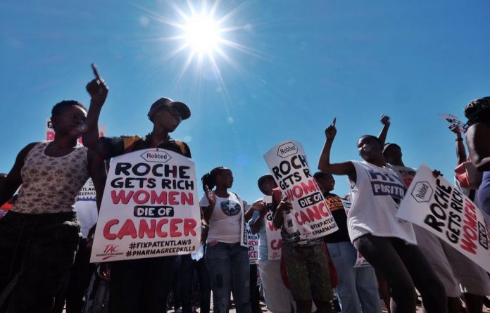 Activists gather at the offices of Roche in Johannesburg to protest against the high price of Herceptin