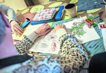 Some lower functioning Care Haven Psychiatric Centre residents are guided through drawing and reading with a staff member as part of a daily programme to keep them active