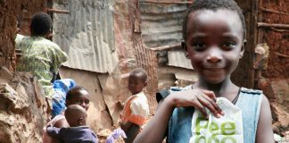 A girl in Kibera holds up the Peepoo