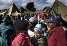 People queue in makeshift camps following past threats of xenophobic attacks in South Africa. Today