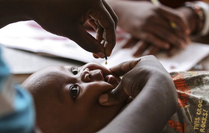 Four-month-old Samson Salo receives a dose of vitamin A at the Madamani Dispensary during Malezi Bora.