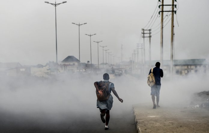 A smoky Port Harcourt street. Doctors have warned of the health-related consequences of the city’s poisonous black soot.