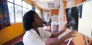 Medical student Inati Mcapazeli studies a chest x-ray at Cape Town’s Brooklyn Chest Hospital on World TB Day 2012.