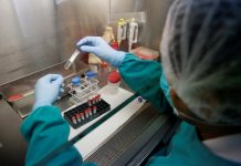 Solutions: A health technician analyses blood samples for tuberculosis in a high-tech TB lab in Lima