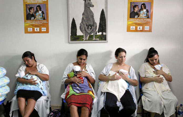 A group of El Salvadoran mothers receive training in kangaroo mother care at a maternity hospital in San Salvador.