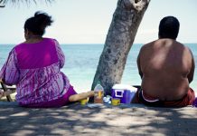 An obese couple sits on the beach. Overweight and obesity have been recognised as crucial health issues and have been included in the sustainable development goals.