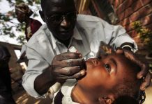 A Nigerian schoolgirl is vaccinated against polio during a mass nationwide polio inoculation.