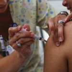 A teenager receives a vaccination
