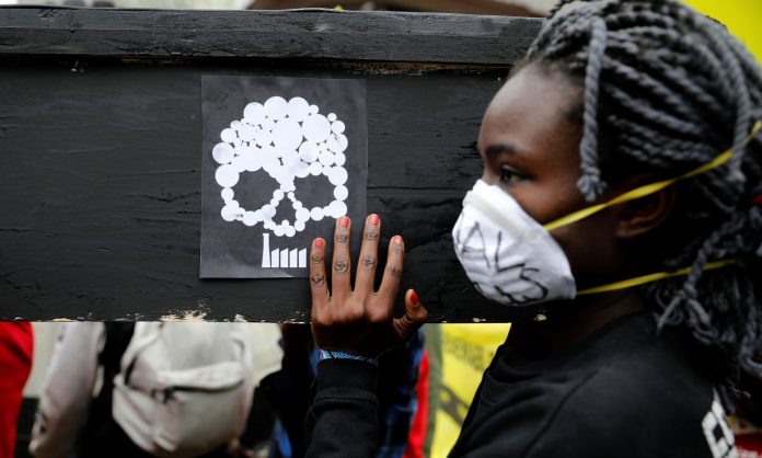 A campaigner in Nairobi carries a coffin during a protest against the construction of a coal plant in Lamu on Kenya’s coast. (Baz Ratner, Reuters)